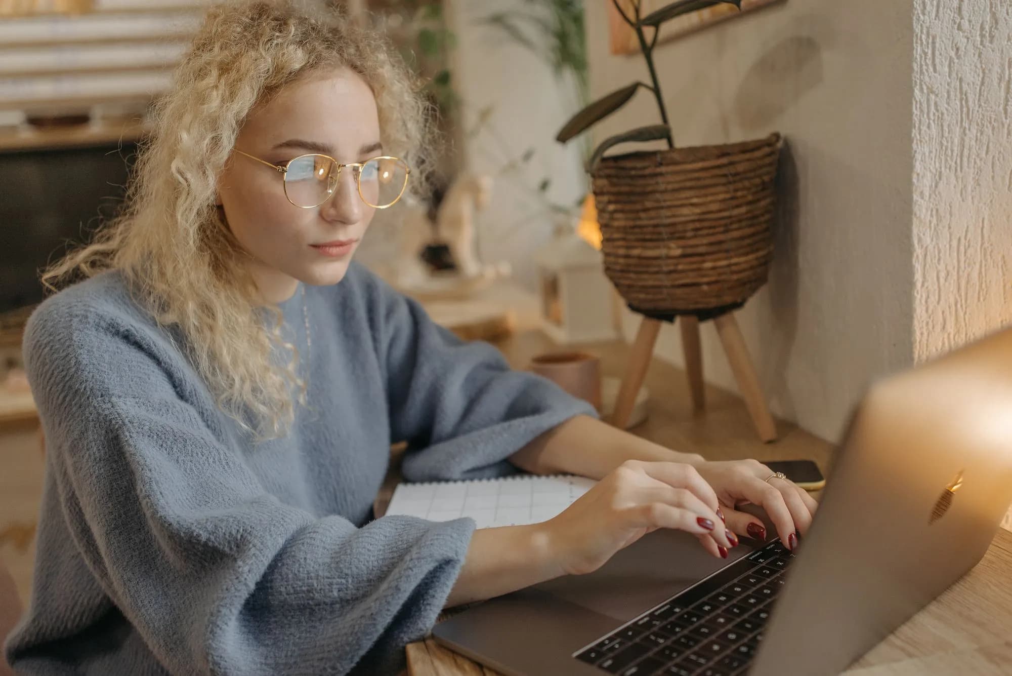 Woman reading on a laptop at home
